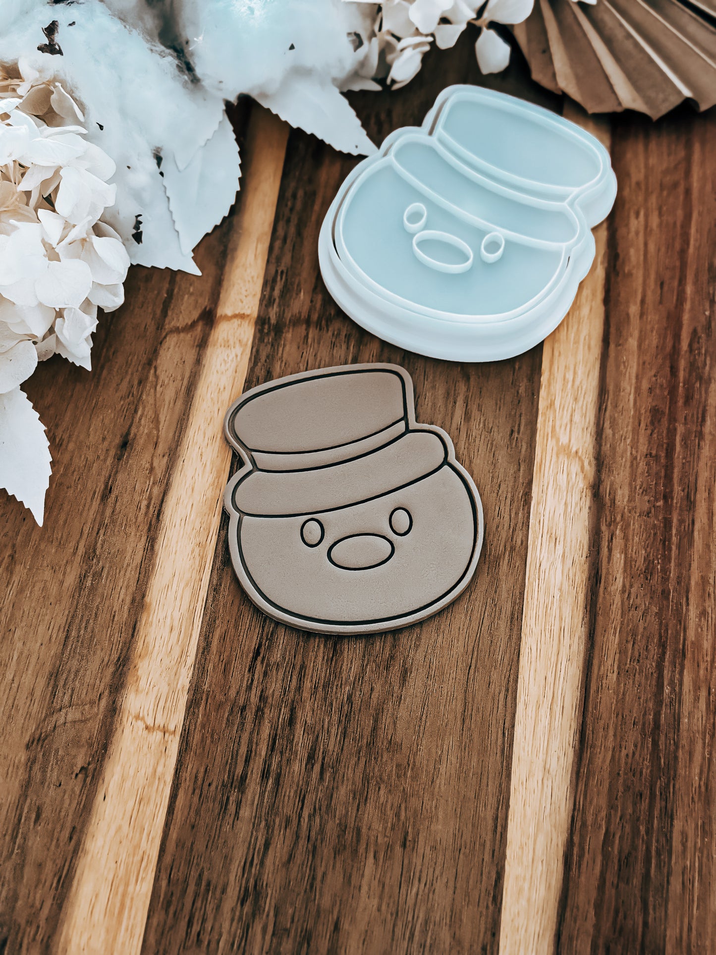 Mr Snowman Christmas cookie stamp and cutter by O'Khach, shown stamped in fondant