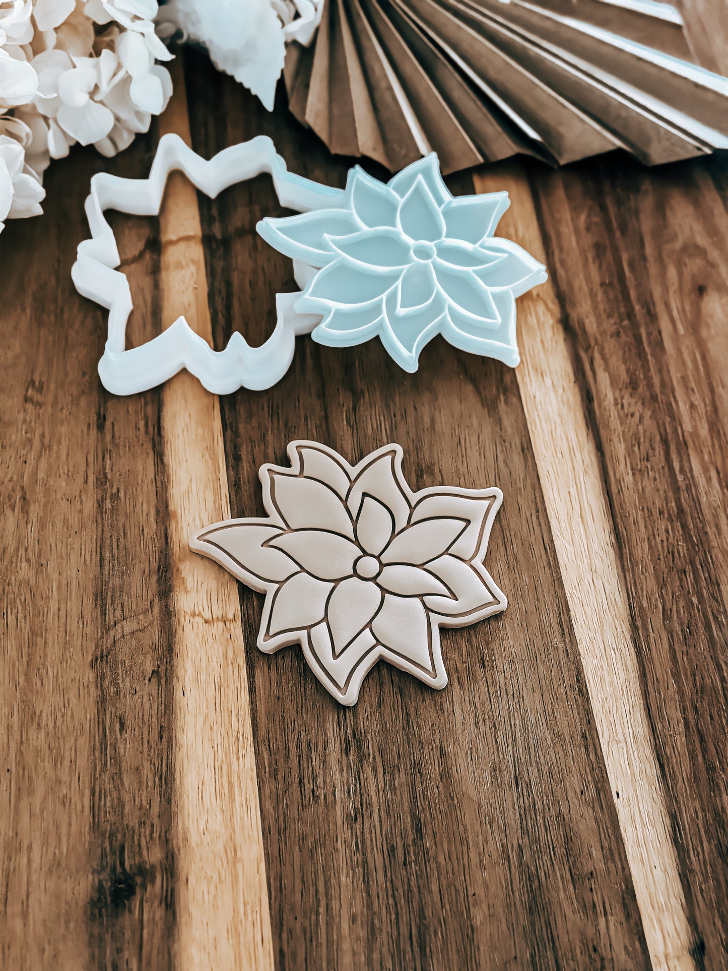 Poinsettias Christmas Flower cookie stamp and cutter by O'Khach, shown stamped in fondant