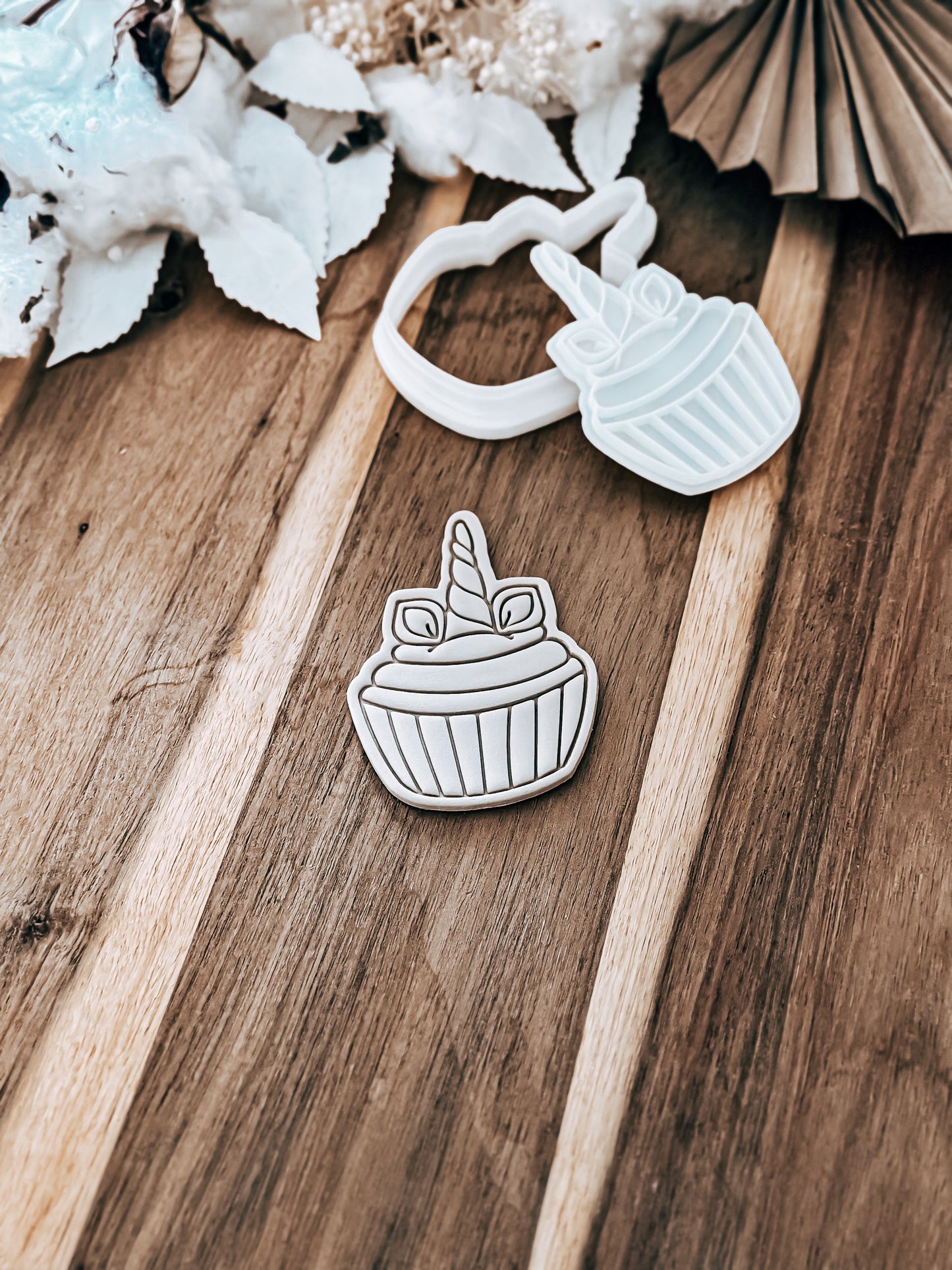 Unicorn Cupcake cookie stamp and cutter by O'Khach, shown stamped in fondant