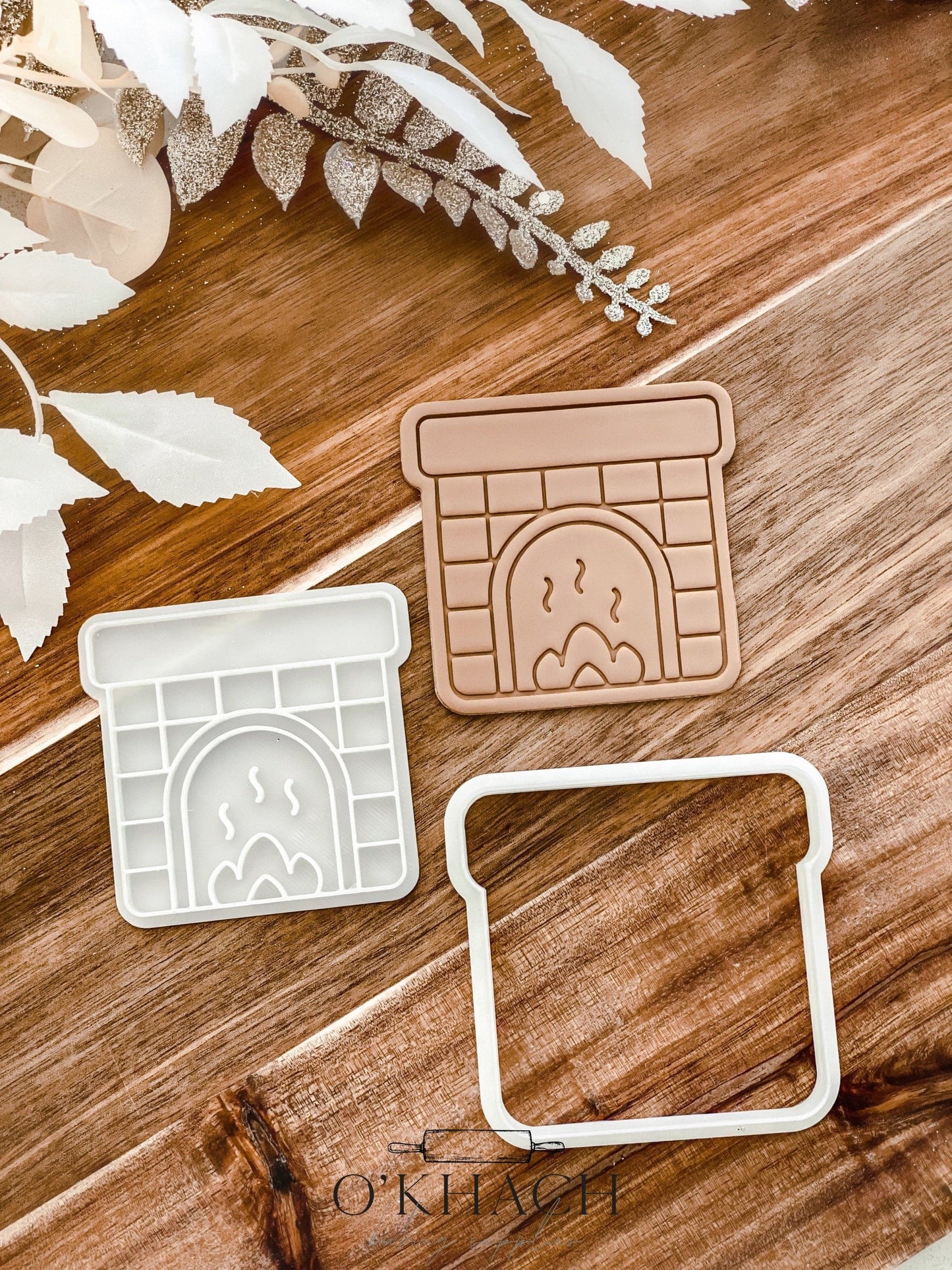 Fireplace Christmas cookie stamp and cutter by O'Khach, shown stamped in fondant
