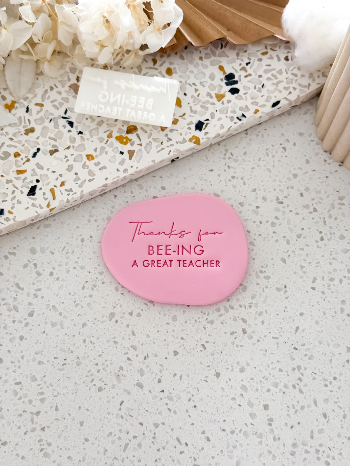 Thanks for Bee-ing a Great Teacher cookie stamp by O'Khach, shown stamped in pink fondant