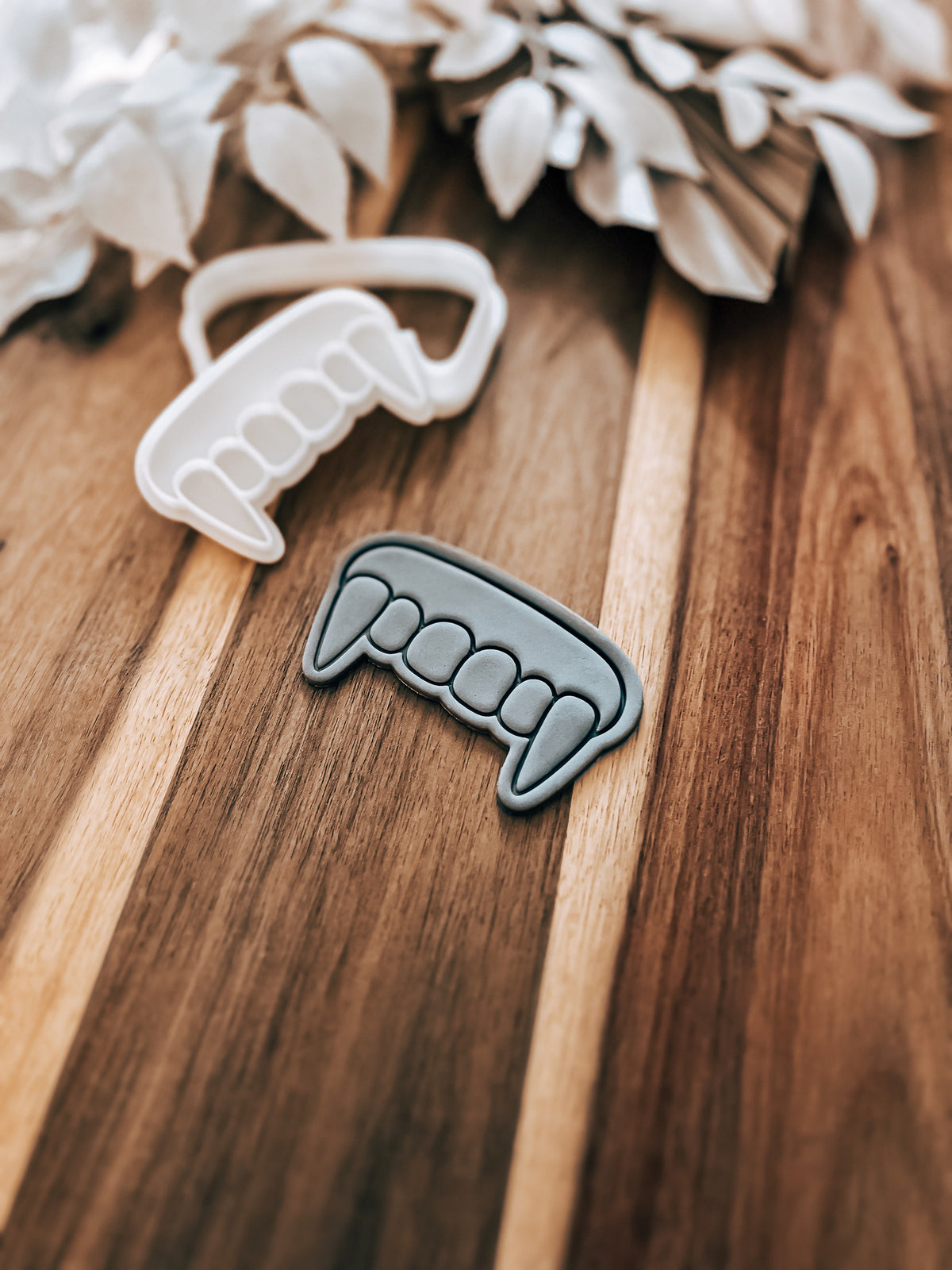 Fangs Halloween cookie stamp and cutter by O'Khach, shown stamped in fondant