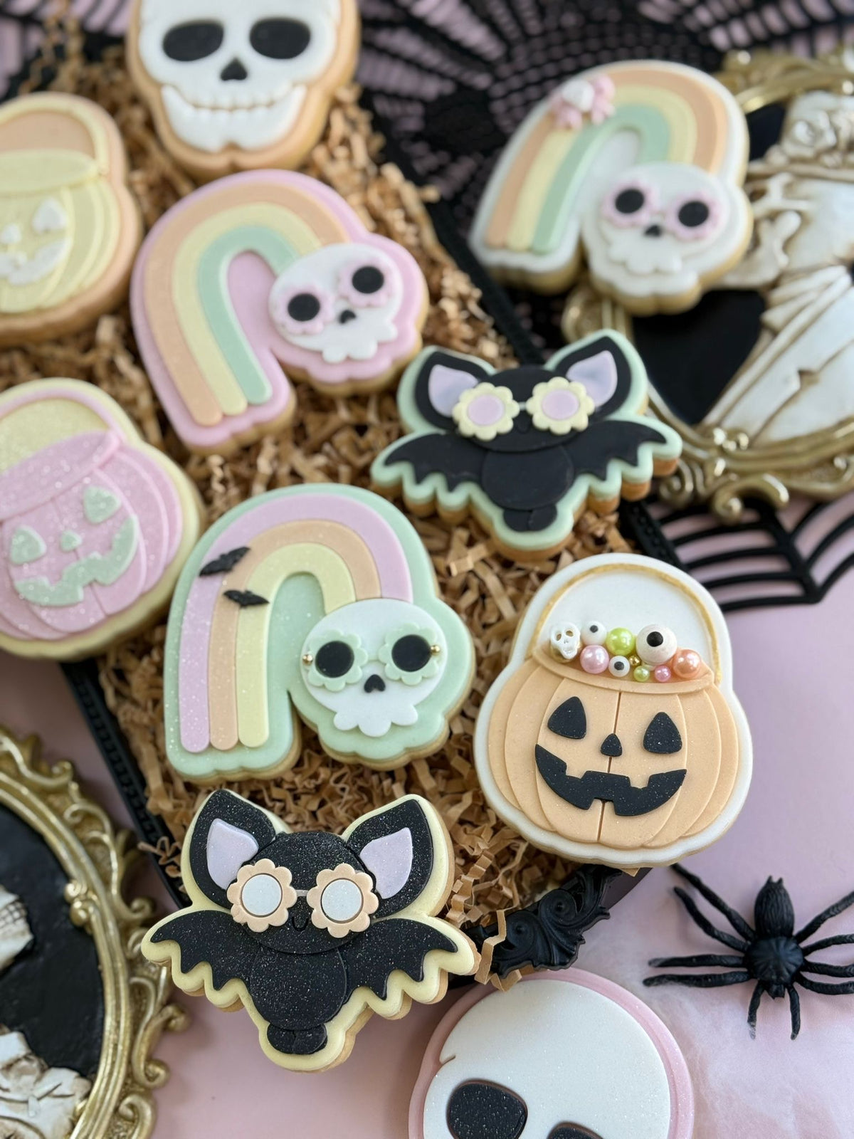 Pastel Halloween fondant cookies with pumpkins, rainbow skulls and bats