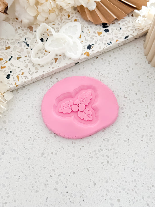 Mini Mistletoe Christmas cookie stamp and cutter by O'Khach, shown stamped in fondant