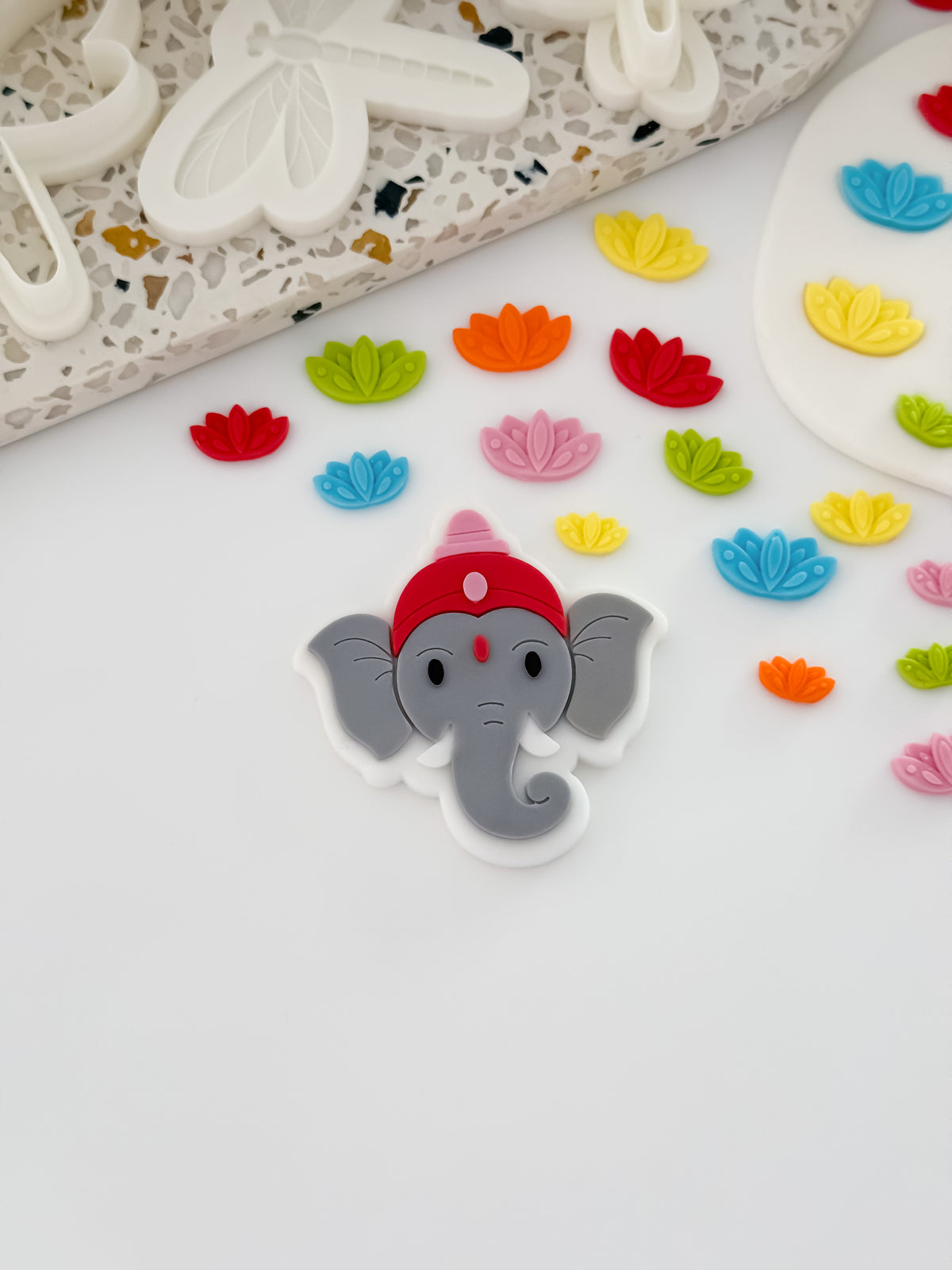 Decorated Ganesha elephant fondant cookie for Diwali, made with the O'Khach Ganesha stamp and cutter, with mini lotus flowers