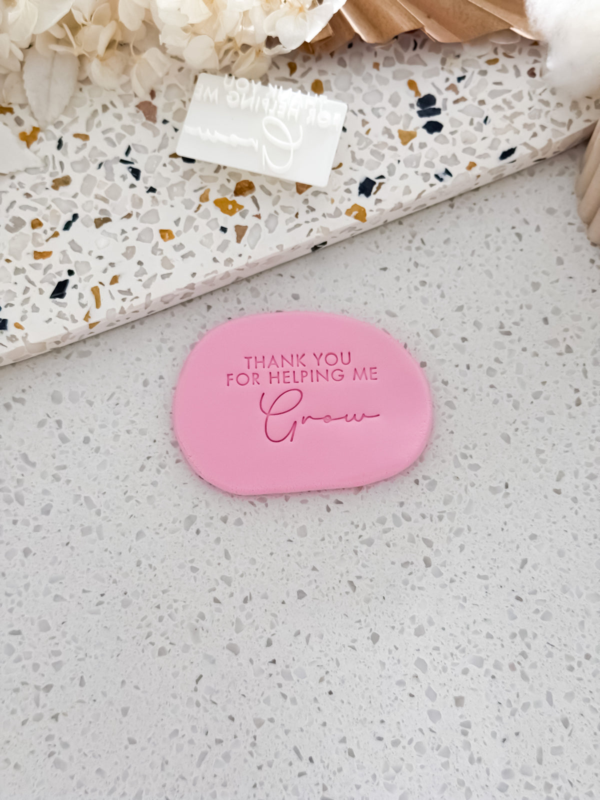 Thank You for Helping Me Grow teacher cookie stamp by O'Khach, shown stamped in pink fondant